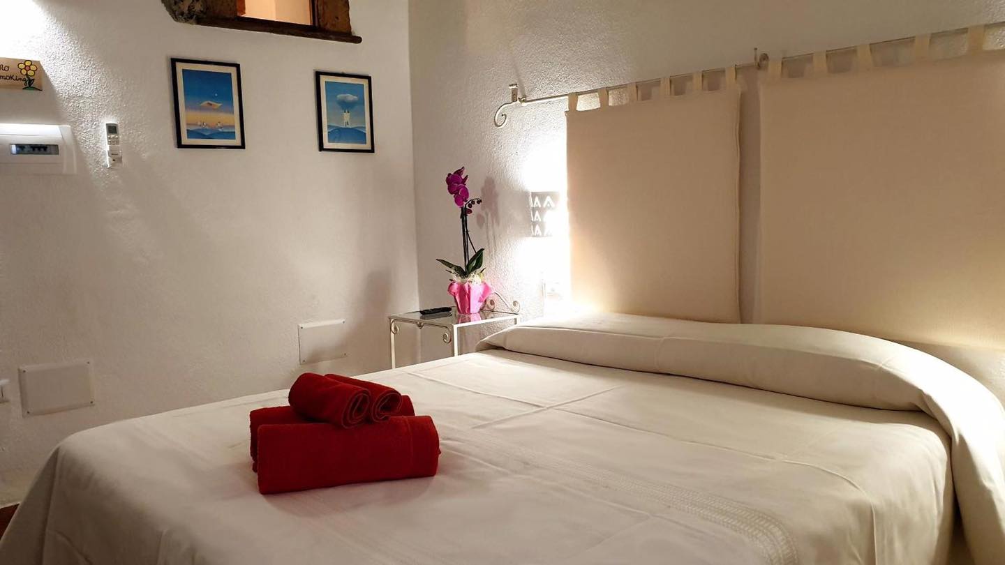Camera 101 Monte Oe con letto matrimoniale e dettagli luminosi